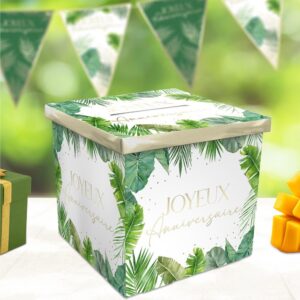 Urne d'anniversaire cubique blanche avec feuilles tropicales vertes et inscription "Joyeux Anniversaire", idéale pour recueillir les cartes et messages lors d'une fête d'anniversaire tropicale.
