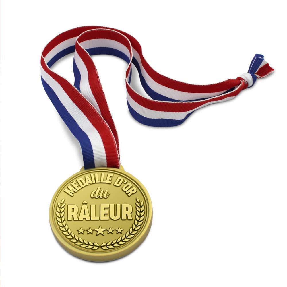 Médaille d'or fantaisie avec un ruban tricolore, gravée avec l'inscription humoristique "MÉDAILLE D'OR du RÂLEUR".