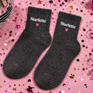Révélez la célébrité qui sommeille en vous avec les chaussettes paillettes "Starlette" ! Design noir et argent étincelant avec broderie cœur fuchsia pour un style ultra-chic.